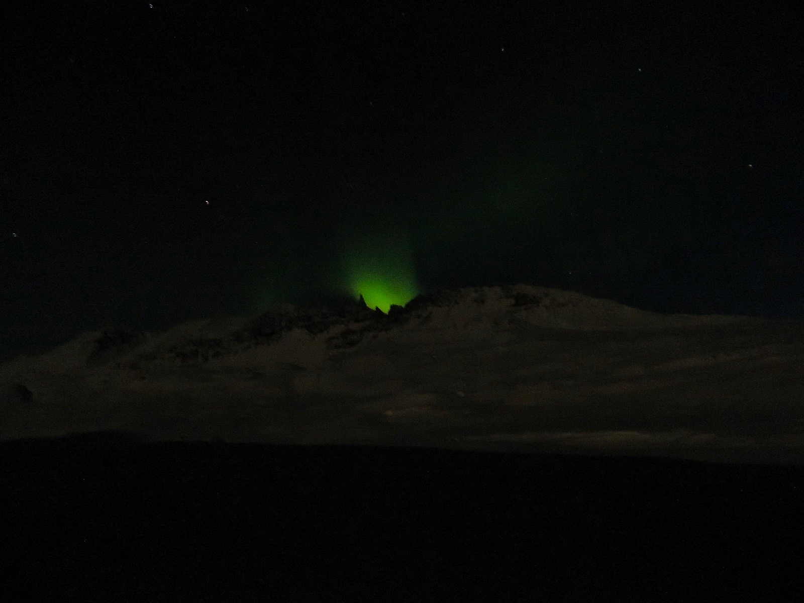 Northern lights behind the mountain range near Akureyri in northern Iceland.